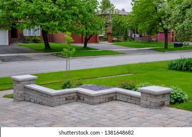 A Seat Wall With Pillars And Natural Stone Coping Helps Define A Tumbled Paver Driveway And Is A Beautiful Landscaping Feature.