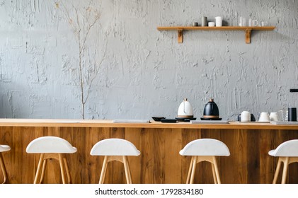 Seat and wooden counter with coffee equipment and wooden shelf on rough cement wall. design for cafe or home
