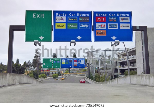 SEATAC, WA - AUGUST 27, 2016: Roadway signage\
at Seattle-Tacoma International Airport\'s Consolidated Rental Car\
Facility guides customers to the return queues and displays all\
rental car companies.