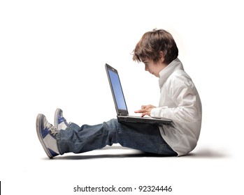 Seated child using a laptop