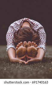 Seated Forward Fold Yoga In Park And Show Feet