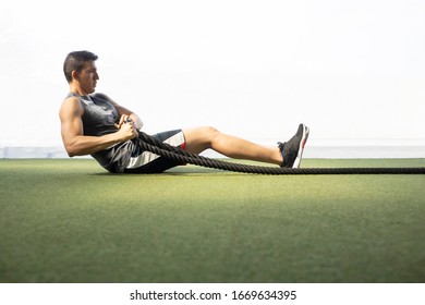 seated man doing sit-ups with rope