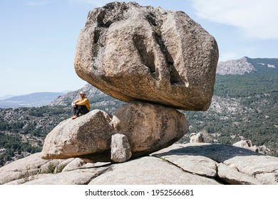 Seated man observes the natural park called Pedriza, in Madrid Spain