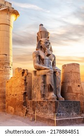 Seated statue of Ramesses II by the Luxor Temple entrance, sunset scenery, Egypt - Shutterstock ID 2178884851