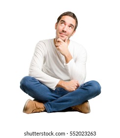 Seated young man wondering - Shutterstock ID 552023263