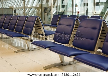 seater bench situating in airport, Empty metallic chairs in airport. Waiting room furniture photo. Airport departure or arrival concept photo. Passenger seat. Indoor detail of public space