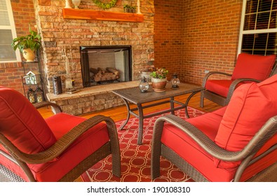 Seating Area Around Gas Stone Fireplace On A Covered Backyard Deck