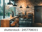 Seating area with bar tables and bar chairs in a modern cafe, industrial style with stone wall, wood and black steel