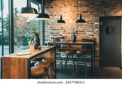 Seating area with bar tables and bar chairs in a modern cafe, industrial style with stone wall, wood and black steel - Powered by Shutterstock