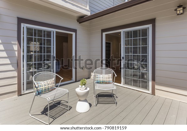Seating Arrangement on sunny deck showing two\
sliding doors.