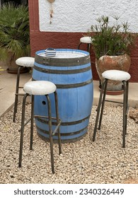 Seating in front of an old pub on the island of Ibiza, an oak barrel serves as a table