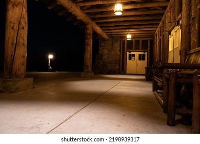 Seating Outside The Closed Old Faithful Lodge At Night, No People In Photo