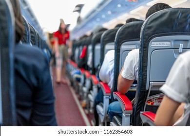 Seats In The Airplane And Passenger Sitting All Area Waiting For The Plane Taking Off From Runway.