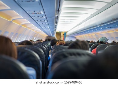 Seats In The Airplane And Passenger Sitting All Area Waiting For The Plane Taking Off From Runway.