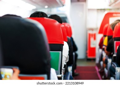 Seats In The Airplane And Passenger Sitting All Area Waiting For The Plane Taking Off From Runway.