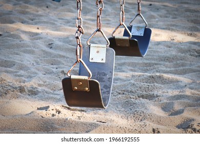 Seats on a swingset at the park