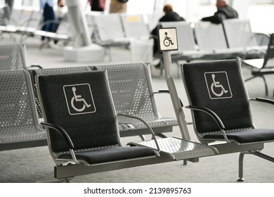 Seats reserved for persons with disabilities inside an airport terminal.