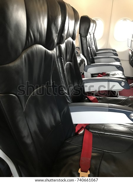 Seats which are shine and clean in airline\
cabin are prepared for\
passengers.