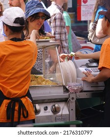 SEATTLE - 17 MAY 2009 - Street Fair in University area.   Asian cooks serving food at concessions.Seattle,  Pacific Northwest