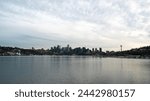 The Seattle city skyline with skyscrapers, the sky needle, distant traffic and Lake Union from the famous tourist destination, Gas Works Park on a cold overcast spring evening