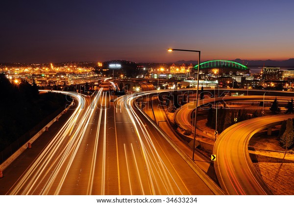 Seattle freeways with colorful streaks of light\
from fast moving\
traffic