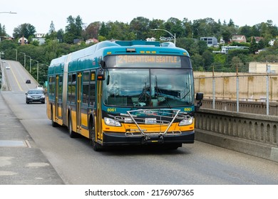 Seattle - July 09, 2022; Teal On Orange Three Door King County Metro Bus Crossing The Magnolia Bridge In Seattle