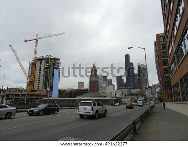 SEATTLE - JUNE 24:   Cars roll down street by\
Seattle King Street Station and construction during summer on June\
24, 2016 in Seattle\
Washington.
