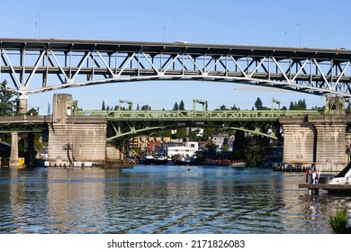 Seattle - June 25, 2022; Interstate 5 on the Ship Canal Bridge towers over the University Bridge in Seattle on a blue sky summer morning. The high bridge has two decks for traffic