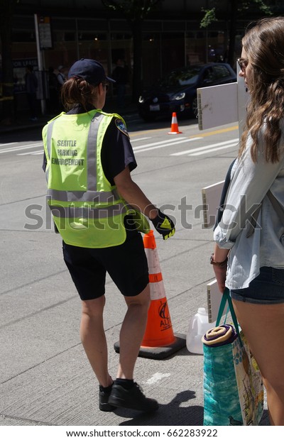 SEATTLE - MAY 21, 2017 - Police halt\
traffic so people can cross at  the University District Street Fair\
(oldest in the\
country),Seattle