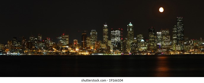 Seattle Skyline And Moon At Night From Alki Beach