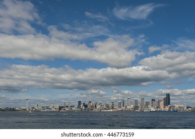 Seattle Skyline. A summertime view of the Seattle skyline looking from west Seattle across Elliott Bay. Cruise ships, ferryboats, kayaks, and freighters are a common sight in this maritime city. - Shutterstock ID 446773159