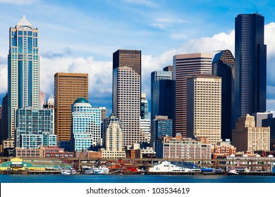 Seattle skyline and waterfront view.  Bright light on a sunny day with clouds. - Powered by Shutterstock