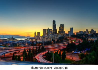 Seattle Skylines And Highway Traffic Motion In The Sunset. The View From Rizal Park In Seattle, Washington, US. City Scape And High Speed Concept.