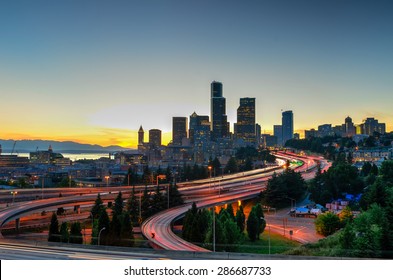 Seattle Skylines And Highway Traffic Motion In The Sunset. The View From Rizal Park In Seattle, Washington, US. City Scape And High Speed Concept.