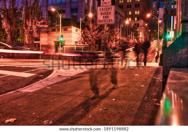 Seattle, United States - October 29 2009 : a long\
exposure in the evening  night with blurred people and cars in\
downtown Seattle