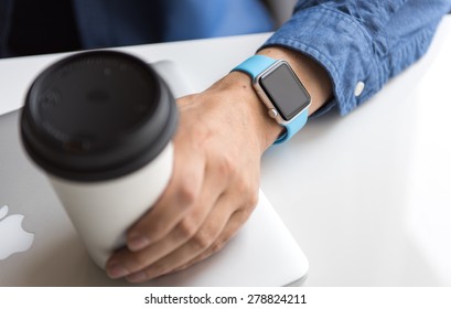 SEATTLE, USA - May 17, 2015: Man Wearing Sport Apple Watch With Blue Rubber Band. 