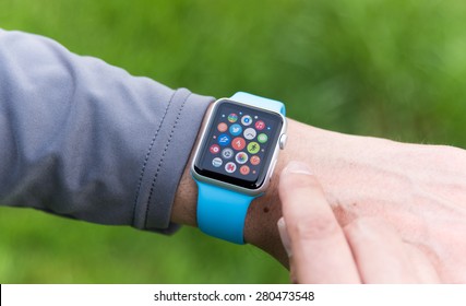 SEATTLE, USA - May 19, 2015: Man Using Apple Watch While Outside. Multiple Apps View.