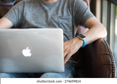 SEATTLE, USA - May 2, 2015: Man Wearing Apple Watch While Working On Computer At Local Coffee Shop