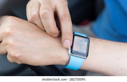 SEATTLE, USA - May 30, 2015: Man Using Maps App On Apple Watch While Driving Car