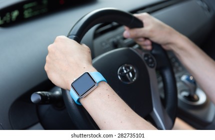 SEATTLE, USA - May 30, 2015: Man Wearing Apple Watch While Driving Toyota Prius