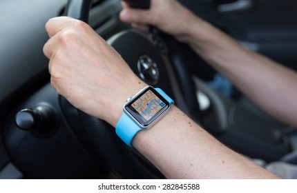 SEATTLE, USA - May 30, 2015: Man Using Maps App On Apple Watch While Driving Toyota Prius