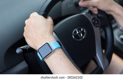 SEATTLE, USA - May 30, 2015: Man Wearing Apple Watch While Driving Toyota Prius