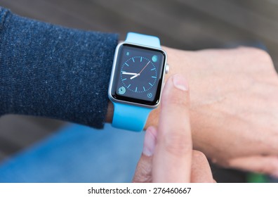 SEATTLE, USA - May 8, 2015: Man Using Watch App On Apple Watch To Check Time.