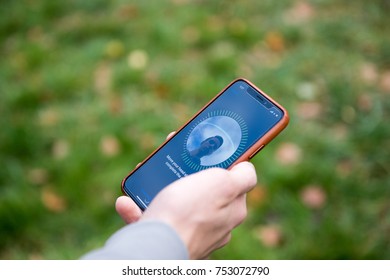 SEATTLE, USA - November 10, 2017: Hand Holding New IPhone X In Silver In Face Recognition Mode