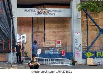 Seattle, WA -11 June 2020 Protest in Capital Hill neighborhood. Capitol Hill Autonomous Zone. Seattle Police Department East Precinct man holding a protest sign that said about police training hours. 