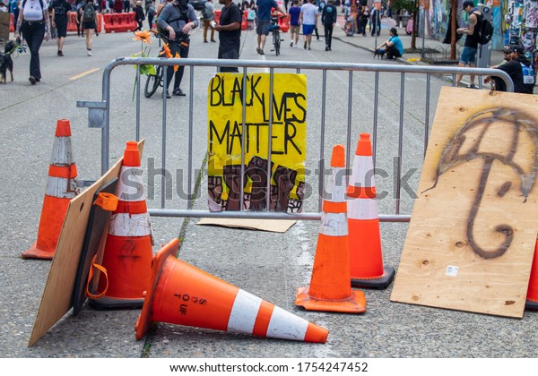 Seattle, WA - 11 June\
2020 Protest in the city, Capital Hill neighborhood. Capitol Hill\
Autonomous Zone. \
Black Lives Matter sign held at protest on\
streets and buildings.\
