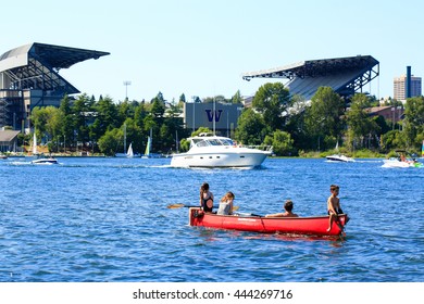 Seattle, WA - March 23, 2011: Children On The Boat, University Of Washington - Husky Stadium  At The Background 