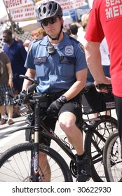 SEATTLE, WA - MAY 17 : Seattle Policeman Stands By On Bicycle During Street Fair May 17, 2009 In Seattle.