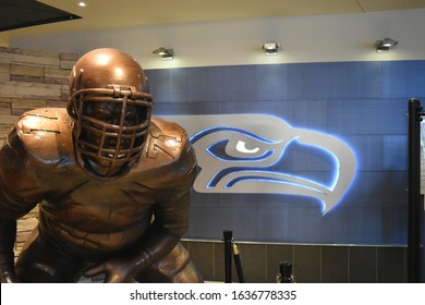 SEATTLE, WA  MAY 18, 2018  A Bronze Statue Of A Football Player And The Logo Of The Seattle Seahawks, A National Football League Team In Washington State.