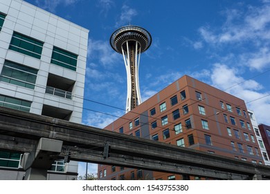 Seattle, WA - October 11, 2019: Looking Up At The Space Needle Through Two Buildings And Monorail Track On Clear Day